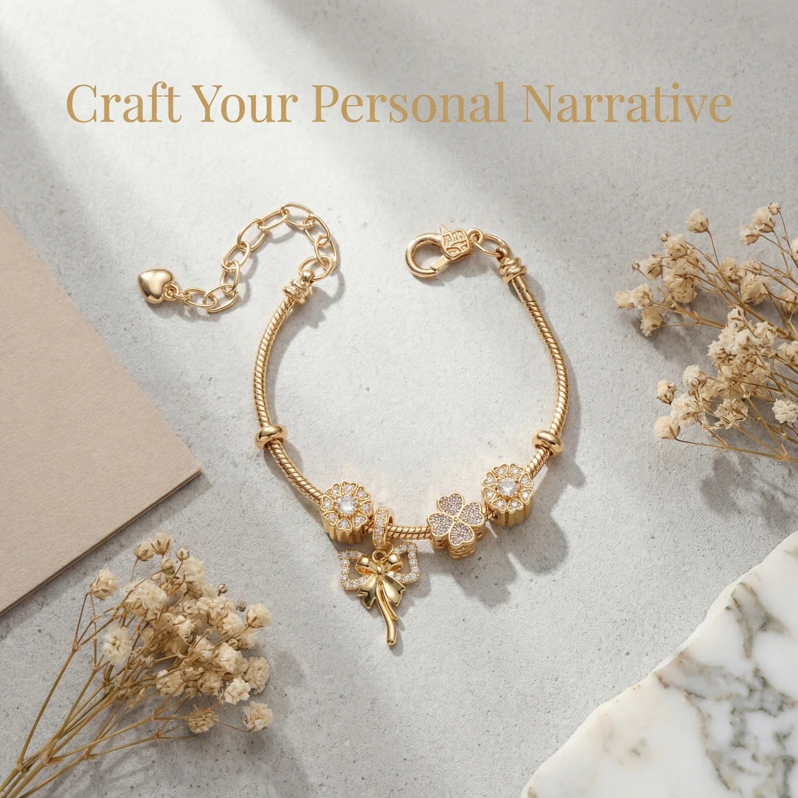 Gold charm bracelet with floral and fairy pendants on marble surface, minimalist jewelry