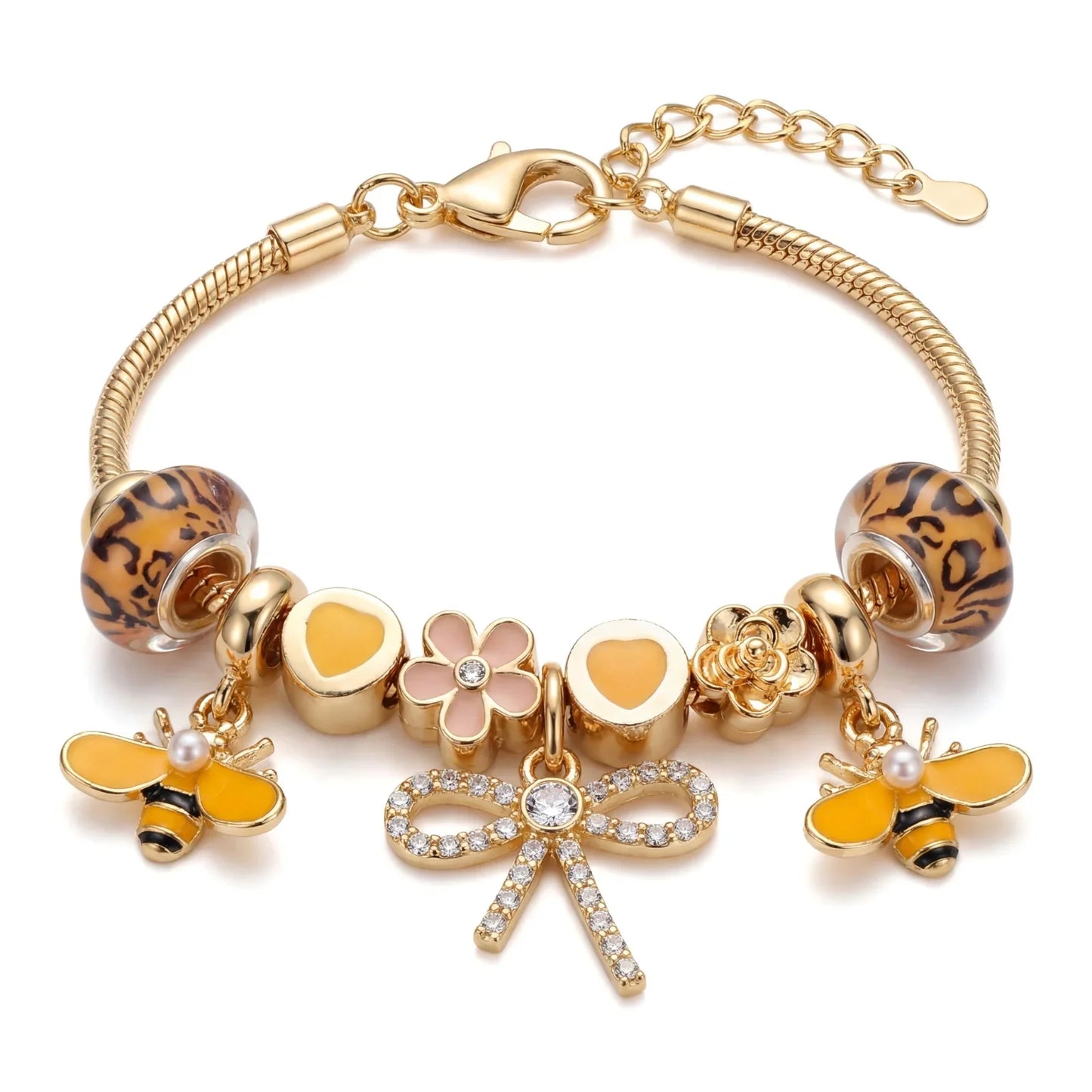 Gold charm bracelet with bee, flower, heart, and crystal bow charms, leopard glass beads