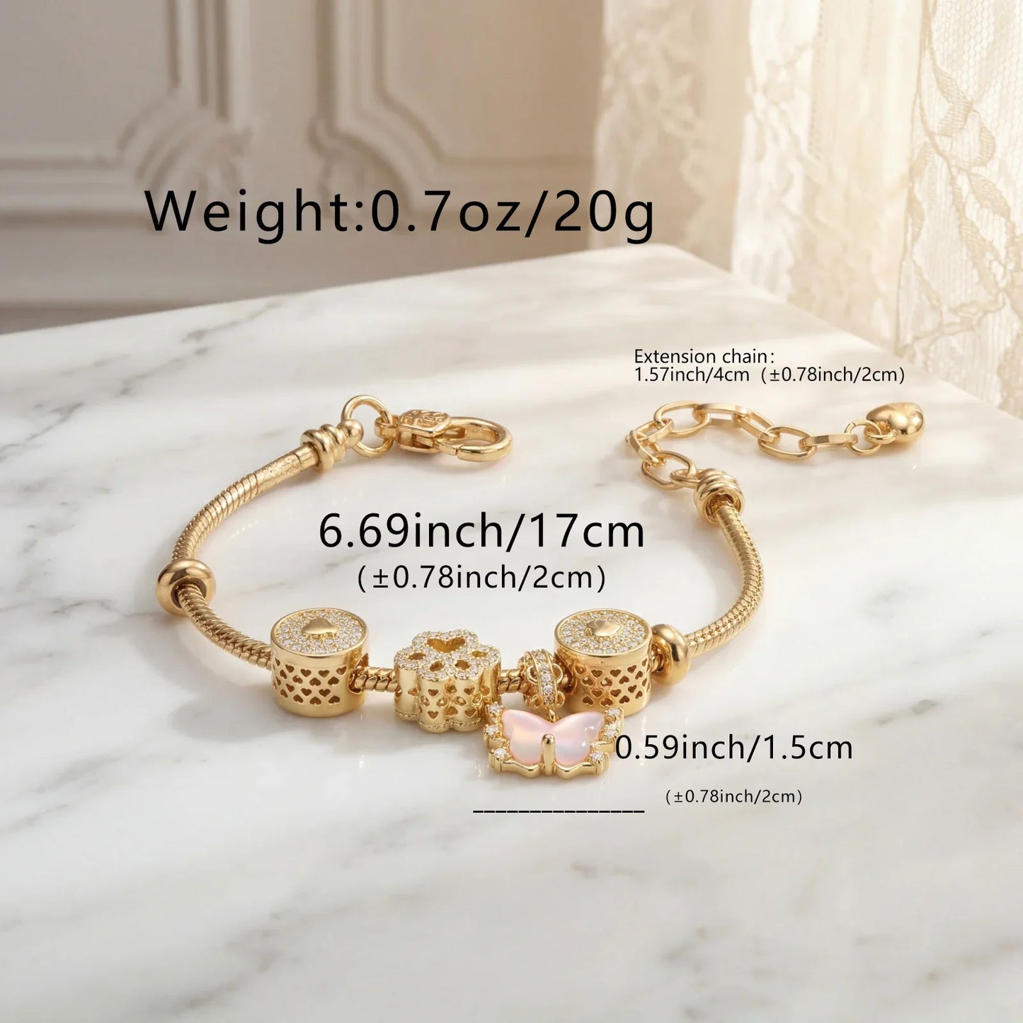Gold charm bracelet with pink butterfly and floral charms on marble surface, detailed with sizes.