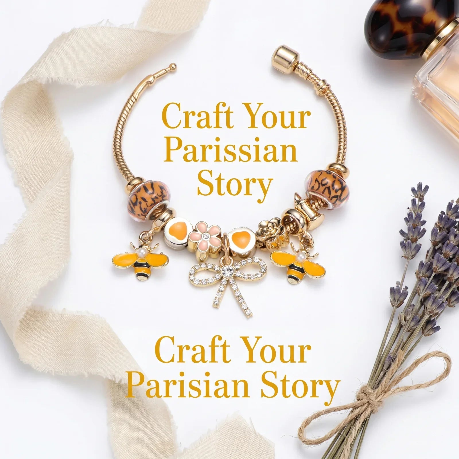 Gold charm bracelet with bees, flowers, and bow, styled with lavender and perfume bottle
