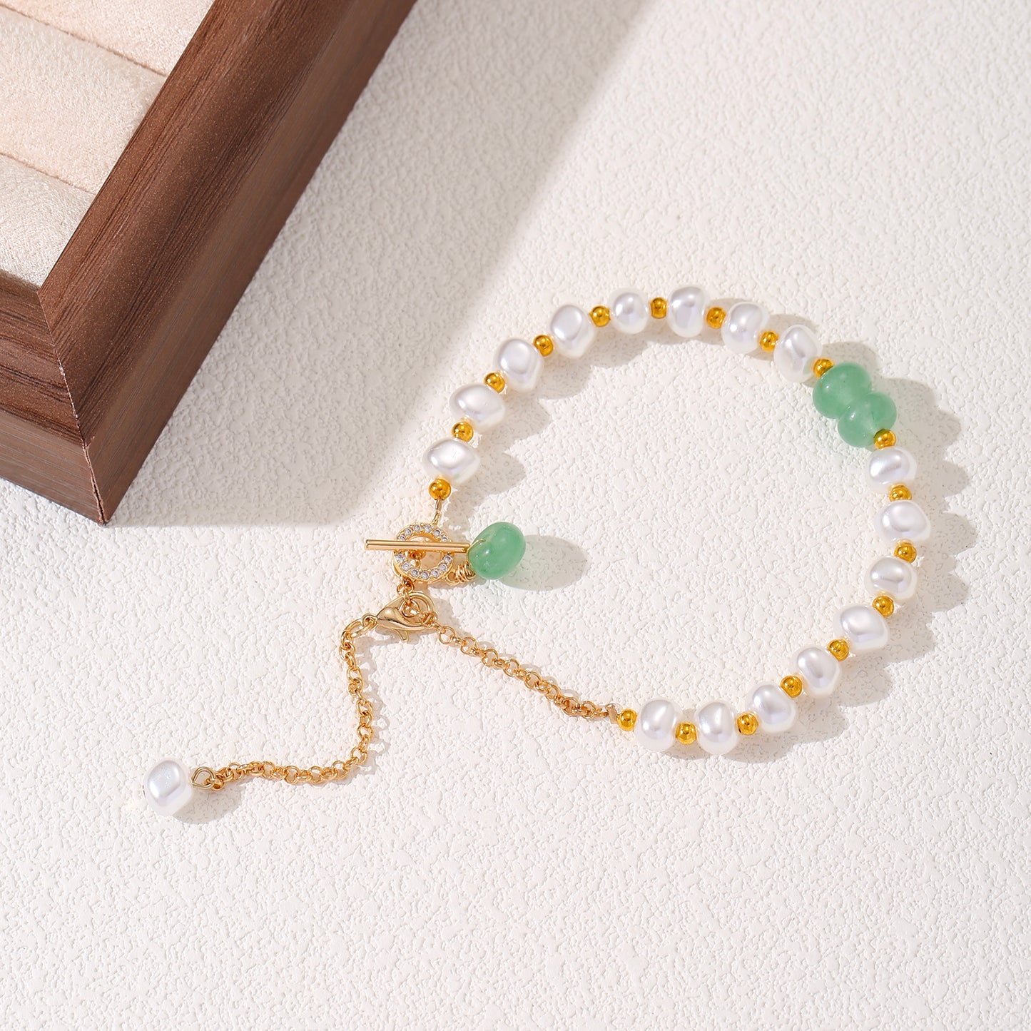 LNCHRAN Golden Plated Faux Pearl Bracelet with Green Stone and Synthetic Zircon Toggle