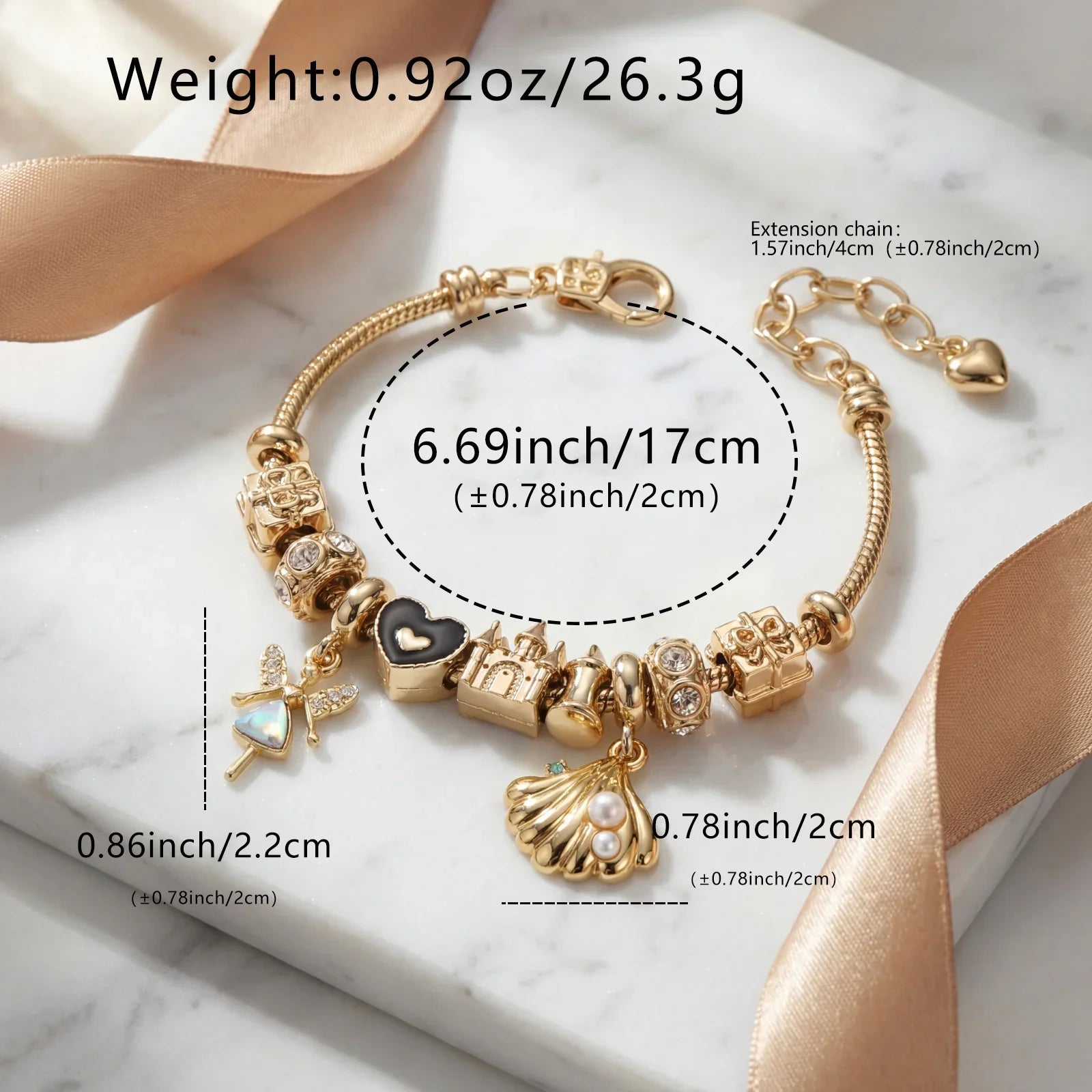 Gold charm bracelet with heart, castle, shell, and fairy charms on marble surface