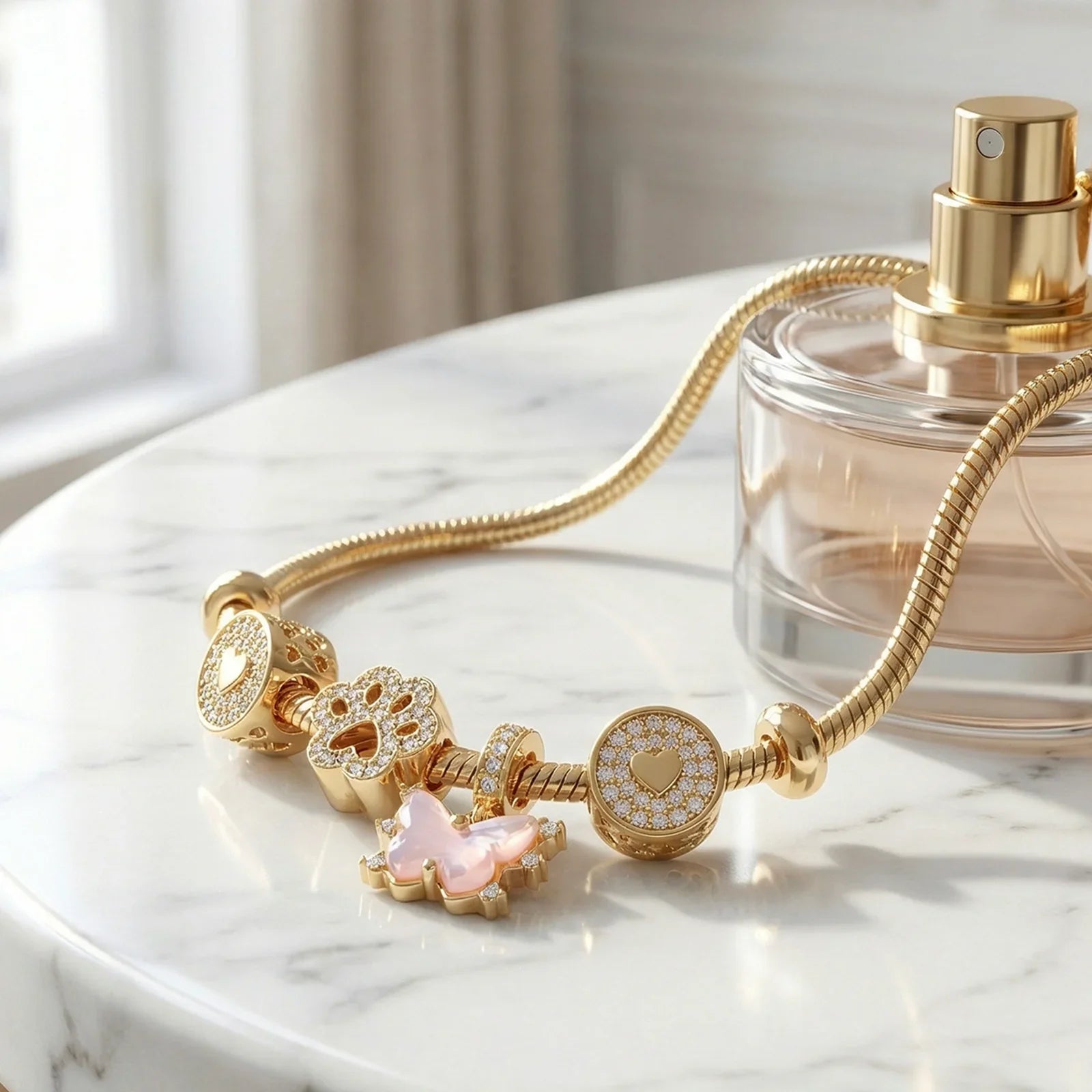 Gold charm bracelet with heart, flower, and butterfly pendants on marble surface